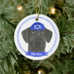 Personalized Black Great Dane Dog Hanukkah Ceramic Ornament<br><div class="desc">Celebrate your favourite mensch on a bench with personalized ornament! This design features a sweet illustration of a black great dane dog with a blue and white yarmulke. For the most thoughtful gifts, pair it with another item from my collection! To see more work and learn about this artist, visit...</div>