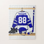 Personalized Blue and White Ice Hockey Jersey Jigsaw Puzzle<br><div class="desc">A personalized ice hockey jersey in blue and white hanging in a sports locker room with a helmet, ice skates and an ice hockey stick. The jersey can be fully customized with the number and name of your choice to make a great gift for the ice hockey fan, ice hockey...</div>