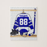 Personalized Blue and White Ice Hockey Jersey Jigsaw Puzzle<br><div class="desc">A personalized ice hockey jersey in blue and white hanging in a sports locker room with a helmet, ice skates and an ice hockey stick. The jersey can be fully customized with the number and name of your choice to make a great gift for the ice hockey fan, ice hockey...</div>