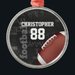 Personalized Chalkboard American Football Metal Ornament<br><div class="desc">A modern American football grid iron design featuring a football on a chalkboard typography background with football terminology in the background. The design features customizable text for the name and number of the football player or grid iron fan. This design has been made in part with graphics licensed by Graphics...</div>