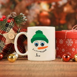 Personalized Custom Name Snowman Green Hat Coffee Mug<br><div class="desc">Sip your favourite warm beverage with a touch of holiday cheer with this personalized coffee mug! Featuring a cheerful snowman wearing a green hat and scarf, this mug brings a festive winter vibe to your morning routine. Add your name or a loved one's for that personal touch, making it a...</div>