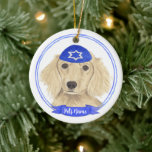 Personalized English Cream Dachshund Dog Hanukkah Ceramic Ornament<br><div class="desc">Celebrate your favourite mensch on a bench with personalized ornament! This design features a sweet illustration of a fawn, tan, or cream english long haired dachshund dog with a blue and white yarmulke. For the most thoughtful gifts, pair it with another item from my collection! To see more work and...</div>