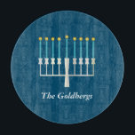 Personalized Family Name Blue Hanukkah Menorah Cutting Board<br><div class="desc">Celebrate Hanukkah with a modern twist using this deep blue design featuring a stylized menorah with glowing golden flames. The family name sits elegantly below in a refined serif font, adding a personal and festive touch. Perfect for holiday hosting, this design is ideal for families who value tradition, warmth, and...</div>