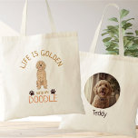 Personalized Golden Doodle Life is Golden Photo Tote Bag<br><div class="desc">Celebrate the joy of your furry friend with this charming Personalized Golden Doodle tote bag. The front features a sweet, apricot-colored hand-drawn illustration paired with the uplifting message, "Life is Golden with my Doodle." On the back, you can easily upload your favorite pet photo and add their name for a...</div>