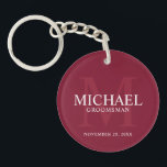 Personalized Groomsmen's name and monogram Keychain<br><div class="desc">Add a personal touch to your wedding with personalized groomsmen keychain. This keychain features personalized groomsman's name with title and wedding date in white and monogram in light burgundy red as background, in classic serif font style, on burgundy red background. Also perfect for best man, father of the bride, ring...</div>