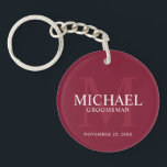 Personalized Groomsmen's name and monogram Keychain<br><div class="desc">Add a personal touch to your wedding with personalized groomsmen keychain. This keychain features personalized groomsman's name with title and wedding date in white and monogram in light burgundy red as background, in classic serif font style, on burgundy red background. Also perfect for best man, father of the bride, ring...</div>