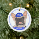 Personalized Masked Frenchie Hanukkah Ceramic Ornament<br><div class="desc">Celebrate your favourite mensch on a bench with a personalized ornament! This design features a sweet illustration of a fawn masked frenchie or french bulldog with a blue and white yarmulke. For the most thoughtful gifts, pair it with another item from my collection! To see more work and learn about...</div>