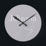 Personalized Modern Family Name Round Clock<br><div class="desc">This is a stylish, modern, grey, personalized, family name design. It is in trending grey with stylish script typography. This chic design is ideal as personalized gift or perfect as a new addition to your home decor. To personalize, simply add your name in the personalize this text box. To change...</div>