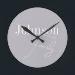 Personalized Modern Family Name Round Clock<br><div class="desc">This is a stylish, modern, grey, personalized, family name design. It is in trending grey with stylish script typography. This chic design is ideal as personalized gift or perfect as a new addition to your home decor. To personalize, simply add your name in the personalize this text box. To change...</div>