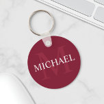 Personalized Monogram and Name Burgundy Red Keychain<br><div class="desc">Personalized Monogram and Name Gift
features personalized name in white and monogram in light burgundy red as background,  in classic serif font style,  
on burgundy red background.

Perfect as holiday gift,  family reunion favours,  thank you gift for groomsmen and gift for any special occasions.</div>