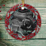 Personalized New Baby Reveal Ultrasound Christmas Ceramic Ornament<br><div class="desc">A Christmas ornament adorned with a beautifully crafted green and red holly wreath design! This ornament is more than just a festive decoration, it's a heartfelt representation of a miracle in the making. It can be personalized with your little bundle of joy's very own ultrasound photo or sonogram photo, along...</div>