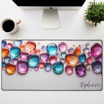 Personalized Rainbow Gemstone  Desk Mat<br><div class="desc">Bring a touch of magic and sparkle to your workspace with this personalized desk mat adorned with vibrant rainbow gemstones. The colourful crystals, set against a sleek black background, create a mesmerizing and inspiring scene. Make it truly yours by adding your name or a motivational quote. The smooth surface provides...</div>