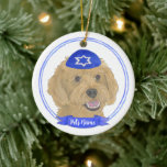 Personalized Red Apricot Gold Doodle Dog Hanukkah Ceramic Ornament<br><div class="desc">Celebrate your favourite mensch on a bench with personalized ornament! This design features a sweet illustration of a red, apricot, or golden doodle dog with a blue and white yarmulke. For the most thoughtful gifts, pair it with another item from my collection! To see more work and learn about this...</div>