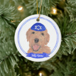 Personalized Red Apricot Gold Doodle Dog Hanukkah Ceramic Ornament<br><div class="desc">Celebrate your favourite mensch on a bench with personalized ornament! This design features a sweet illustration of a red, apricot, or golden doodle dog with a blue and white yarmulke. For the most thoughtful gifts, pair it with another item from my collection! To see more work and learn about this...</div>