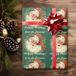 Personalized Santa Christmas Wrapping Paper<br><div class="desc">This festive personalized Christmas gift wrap features a wonderful vintage portrait of Santa Claus with his bushy beard. He wears a sprig of holly with a red berry. The portrait is surrounded by a wreath of pine needles on a dark green background. There are two lines for your custom text...</div>