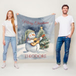 Personalized Snowman Guitar Christmas Fleece Blanket<br><div class="desc">Wrap yourself in warmth and joy with our Snowman Guitar Christmas Fleece Blanket. Luxurious softness meets festive design, making it a perfect holiday gift! Add that special name for that special touch! Exclusive designs from My Baby Boutique!</div>