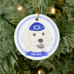 Personalized White Doodle Dog Hanukkah Ceramic Ornament<br><div class="desc">Celebrate your favourite mensch on a bench with personalized ornament! This design features a sweet illustration of a white doodle dog with a blue and white yarmulke. For the most thoughtful gifts, pair it with another item from my collection! To see more work and learn about this artist, visit her...</div>