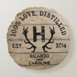 Personalized Wood Bourbon Barrel Wedding Monogram Round Pillow<br><div class="desc">Celebrate the wedding day or anniversary of a special bride and groom with this customizable keepsake styled like a distillery logo stamped on the lid of an oak bourbon barrel! A monogram between deer antlers, couple's names and wedding year appear below arched text that reads “100% Love, Distilled, ” on...</div>