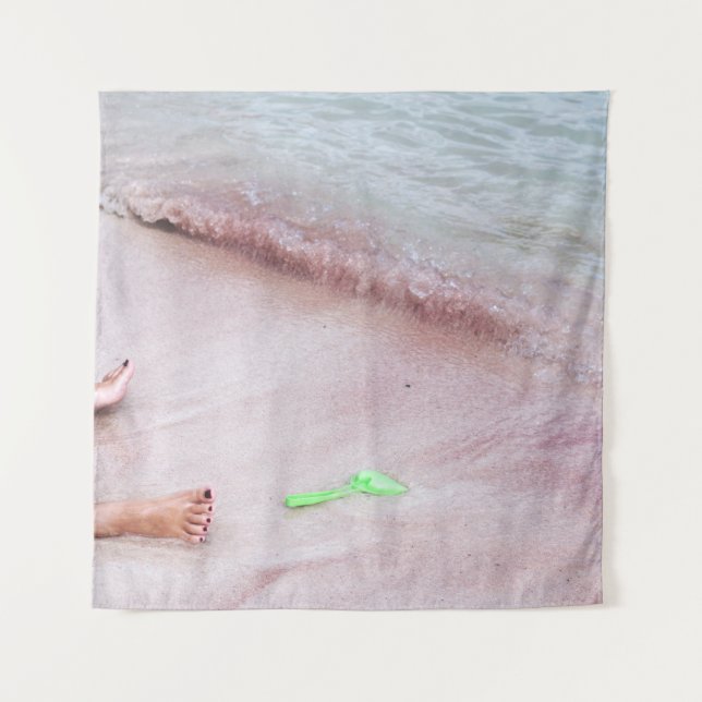 Person's foot beside green shovel on seashore tapestry (Front)