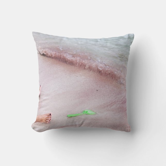 Person's foot beside green shovel on seashore throw pillow (Front)