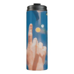 Persons hand with blue light thermal tumbler