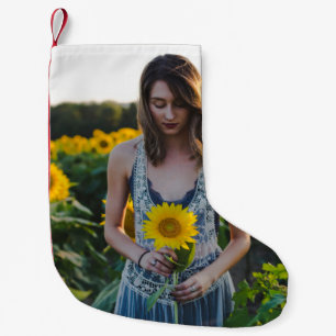 Petite Chaussette De Noël Femme debout sur le terrain de tournesol