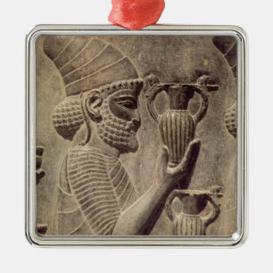 Phoenician carrying two offering, detail relief metal ornament