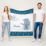 Photo of a Cute Snowman in Winter - Christmas Fleece Blanket<br><div class="desc">A blanket with a cute photograph of a little snowman. Standing outside in the winter with snow falling all around. This cute little guy is dressed up in blue knitted hat and scarf. Snowflake pattern with a dark blue background along the top and bottom border.</div>