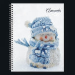 Photo of a Cute Snowman in Winter - Christmas Notebook<br><div class="desc">A personalized spiral notebook with a cute photograph of a little snowman. Standing outside in the winter with snow falling all around. This cute little guy is dressed up in blue knitted hat and scarf.</div>