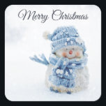 Photo of a Cute Snowman in Winter - Christmas Square Sticker<br><div class="desc">Christmas stickers with a cute photograph of a little snowman. Standing outside in the winter with snow falling all around. This cute little guy is dressed up in blue knitted hat and scarf.</div>