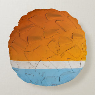 Photo of orange, white, and blue artwork round pillow