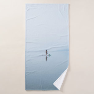 PHOTO OF PERSON ON CALM BODY OF WATER BATH TOWEL
