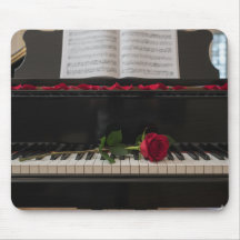 Piano with red rose and rose petals