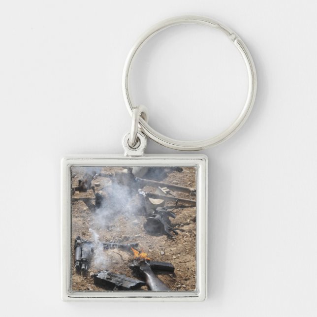 Pieces of enemy weapons lay out to cool off keychain (Front)