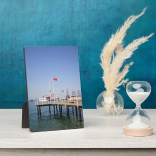 Pier with view of the marine with yacht in Turkey Plaque