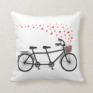 Pillow with tandem bicycle and flying red hearts