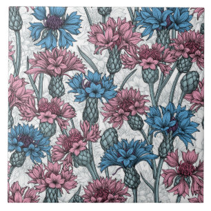 Pink and blue cornflowers on white tile