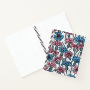 Pink and blue cornflowers, wild flowers on white notebook