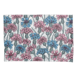 Pink and blue cornflowers, wild flowers on white pillowcase