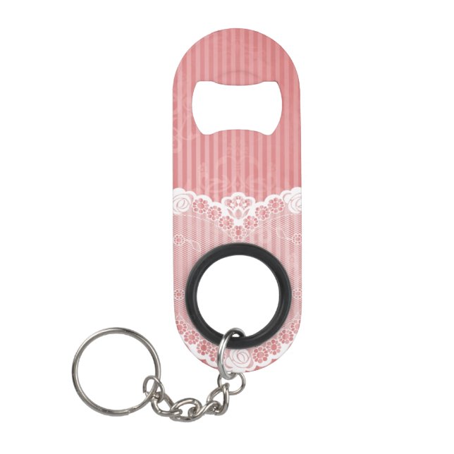 Pink and white background with black lace keychain bottle opener (Front)