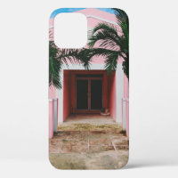 Pink and white concrete house near green trees und
