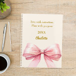 Pink bow beige cream quote 2026 planner<br><div class="desc">A soft beige, cream coloured background, decorated with a large pink bow. Quote: Live with intention. Plan with purpose.</div>