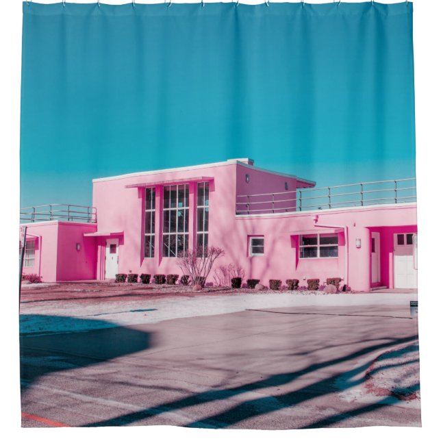 Pink concrete building under clear blue sky (Front)
