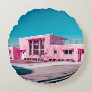 Pink concrete building under clear blue sky round pillow