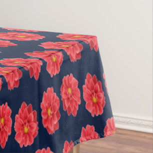 Pink dahlia flower on blue tablecloth