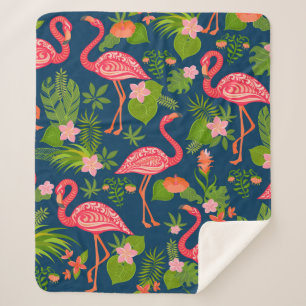 Pink flamingo ornament on a striped turquoise back sherpa blanket