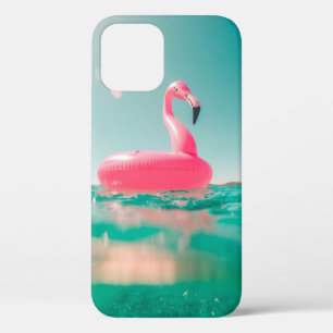 Pink flamingo swim ring on body of water in summer iPhone 12 case