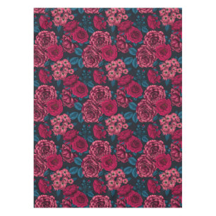 Pink, red and bi-colour roses with blue leaves on  tablecloth