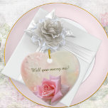 Pink Rose Engagement Heart  Ceramic Ornament<br><div class="desc">Elegant ceramic "marry me" keepsake ornament features a simple gorgeous pink rose on a misty water colour pink background with dewdrops. Perfect accessory for a marriage proposal before choosing rings . Just edit the text front and back in the easy Zazzle text editor.</div>