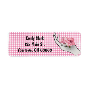pink rose in hand on gingham